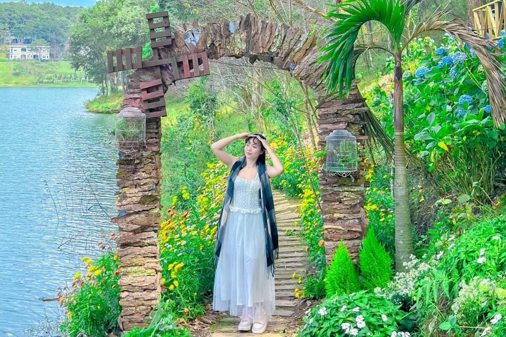 Với tà váy trắng dịu dàng, du khách thêm nổi bật trước cổng vòm có mô hình cối xay gió